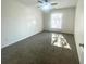 A sunny bedroom with neutral carpet and a window, showcasing a serene and inviting atmosphere at 3078 Parc Lorraine, Lithonia, GA 30038
