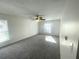 Bright bedroom with neutral carpet, ceiling fan, and double windows providing natural light at 3078 Parc Lorraine, Lithonia, GA 30038