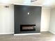 Close-up of a modern fireplace featuring laminate floors, and a stylish fireplace at 3078 Parc Lorraine, Lithonia, GA 30038