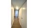 Long hallway features durable wood-look flooring and neutral walls, creating a seamless flow at 3078 Parc Lorraine, Lithonia, GA 30038