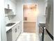 Renovated kitchen featuring stainless steel appliances, white cabinets, quartz countertops, and marble floors at 3078 Parc Lorraine, Lithonia, GA 30038