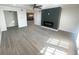 Cozy living room featuring sleek hardwood floors, modern fireplace, and chandelier lit dining room at 3078 Parc Lorraine, Lithonia, GA 30038