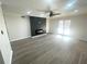 Modern living room featuring sleek hardwood floors, ceiling fan, and a stylish fireplace at 3078 Parc Lorraine, Lithonia, GA 30038