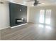 Bright living room featuring laminate floors, ceiling fan, and a stylish fireplace at 3078 Parc Lorraine, Lithonia, GA 30038