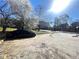 Open parking lot, showing a black sedan, and trees blossoming in the background at 3078 Parc Lorraine, Lithonia, GA 30038