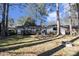 Backyard with a deck, treelined border, and fire pit for gatherings at 3331 Casa Linda Dr, Decatur, GA 30032
