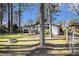 Backyard with a fence, treelined border, and fire pit for gatherings at 3331 Casa Linda Dr, Decatur, GA 30032