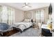 Bedroom featuring a bed, dark wood floors, a ceiling fan, and vine-like window coverings at 3331 Casa Linda Dr, Decatur, GA 30032