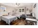 Bedroom featuring two twin beds, dark wood floors, a ceiling fan, and cool decor accents at 3331 Casa Linda Dr, Decatur, GA 30032