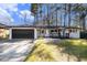 Charming single-story home with a dark garage door, shutters, and a inviting front porch at 3331 Casa Linda Dr, Decatur, GA 30032