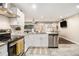 Bright kitchen featuring stainless appliances, a granite countertop and an open view to the living area at 3331 Casa Linda Dr, Decatur, GA 30032