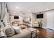 An inviting living room with a gray sectional couch, dark floors, and a view of the kitchen at 3331 Casa Linda Dr, Decatur, GA 30032