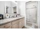 Clean bathroom with granite countertops, neutral tile, and glass enclosed shower at 4809 Shae Ct, Powder Springs, GA 30127