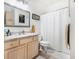 Bright bathroom featuring a marble countertop, framed mirror, and shower with white curtain at 4809 Shae Ct, Powder Springs, GA 30127