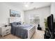 Bright bedroom features a cozy bed, bedside tables, and a large window at 4809 Shae Ct, Powder Springs, GA 30127