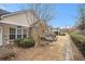 Brick home exterior showcasing a charming patio area with beautiful landscaping and a peaceful, inviting atmosphere at 4809 Shae Ct, Powder Springs, GA 30127