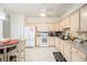 Bright kitchen with white appliances, light wood cabinets, and an adjacent dining area at 4809 Shae Ct, Powder Springs, GA 30127