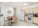 Bright kitchen with white appliances, ample counter space, and an adjacent dining area at 4809 Shae Ct, Powder Springs, GA 30127