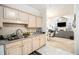 Bright kitchen with light wood cabinets offering views to the open-concept living room at 4809 Shae Ct, Powder Springs, GA 30127
