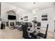 Open-concept living and dining area with fireplace, large screen TV, modern furniture and a modern chandelier at 4809 Shae Ct, Powder Springs, GA 30127