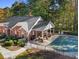 Aerial view of community pool with a covered seating area and beautifully landscaped surroundings at 4809 Shae Ct, Powder Springs, GA 30127