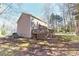 Expansive backyard showcasing the home's exterior, a spacious deck, and mature trees at 4852 Gold Nugget Way, Sugar Hill, GA 30518