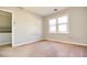 Bedroom features a window for natural light and neutral walls, creating a serene atmosphere at 4852 Gold Nugget Way, Sugar Hill, GA 30518