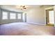 Spacious bedroom with neutral tones, multiple windows, and a ceiling fan at 4852 Gold Nugget Way, Sugar Hill, GA 30518