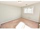 Bright bedroom featuring a window, carpeted floors, and neutral walls, creating a cozy and inviting space at 4852 Gold Nugget Way, Sugar Hill, GA 30518