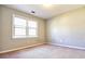 Neutral bedroom featuring two windows, carpeted floors, and ready for customization at 4852 Gold Nugget Way, Sugar Hill, GA 30518