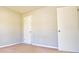 Bedroom featuring carpeted floors, neutral walls, and two white doors at 4852 Gold Nugget Way, Sugar Hill, GA 30518