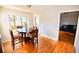 Bright dining area features a round table set, wood floors, and plenty of natural light at 4852 Gold Nugget Way, Sugar Hill, GA 30518