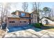 Charming two-story home with a two-car garage and manicured landscaping and an attractive exterior at 4852 Gold Nugget Way, Sugar Hill, GA 30518