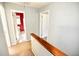 Hallway featuring a wooden handrail and neutral walls, connecting to the bathroom and other rooms at 4852 Gold Nugget Way, Sugar Hill, GA 30518