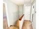 Hallway featuring a wooden handrail and neutral walls, connecting various rooms in the home at 4852 Gold Nugget Way, Sugar Hill, GA 30518