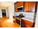 Well-equipped kitchen with stainless steel appliances, stylish backsplash, and wood cabinets at 4852 Gold Nugget Way, Sugar Hill, GA 30518
