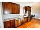 Kitchen with granite countertops, stainless steel appliances, and dark wood cabinets at 4852 Gold Nugget Way, Sugar Hill, GA 30518