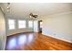 Bright living room featuring hardwood floors, neutral paint and a modern ceiling fan at 4852 Gold Nugget Way, Sugar Hill, GA 30518