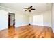 Bright living room featuring hardwood floors, neutral paint, white trim and a modern ceiling fan at 4852 Gold Nugget Way, Sugar Hill, GA 30518