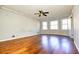 Bright living room featuring hardwood floors, neutral paint and a modern ceiling fan at 4852 Gold Nugget Way, Sugar Hill, GA 30518