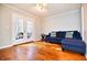 Cozy living room with hardwood floors, a comfortable sofa, and bright natural light at 4852 Gold Nugget Way, Sugar Hill, GA 30518
