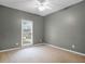 Neutral bedroom with carpet flooring, a bright window, and ample space at 9135 Woodhaven Way, Mcdonough, GA 30253