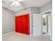 Bright bedroom with doorway to bathroom, featuring modern ceiling fan and plush carpeting at 9135 Woodhaven Way, Mcdonough, GA 30253