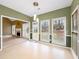 Bright breakfast nook featuring multiple windows, backyard access and views into the living room with a fireplace at 9135 Woodhaven Way, Mcdonough, GA 30253