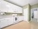 Classic kitchen with white cabinetry, light countertops, modern appliances, and ample space for cooking at 9135 Woodhaven Way, Mcdonough, GA 30253