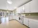 Open-concept kitchen connected to breakfast nook, featuring white cabinetry, modern appliances, and natural light at 9135 Woodhaven Way, Mcdonough, GA 30253