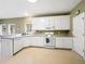 Kitchen with white cabinets, ample counter space, a built-in microwave, and a bright, open layout at 9135 Woodhaven Way, Mcdonough, GA 30253