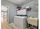 Efficient laundry room with washer, dryer, sink, and cabinets, offering practicality and organization at 9135 Woodhaven Way, Mcdonough, GA 30253