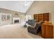 Inviting living room with a fireplace, plush carpeting, vaulted ceilings and a comfortable leather sofa at 9135 Woodhaven Way, Mcdonough, GA 30253