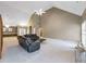 Spacious living room with vaulted ceilings, fan, plush carpeting and comfortable leather seating at 9135 Woodhaven Way, Mcdonough, GA 30253